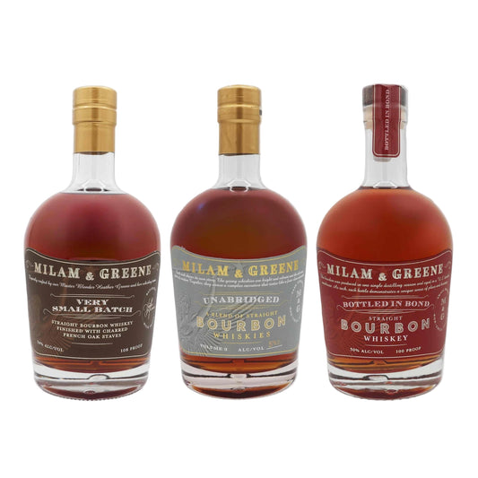 Three bottles of Milam & Greene bourbon whiskey on a gray background